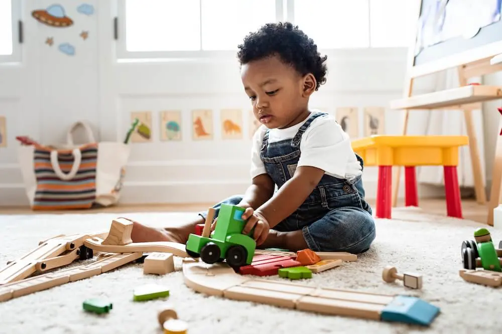 toddler playing with trains