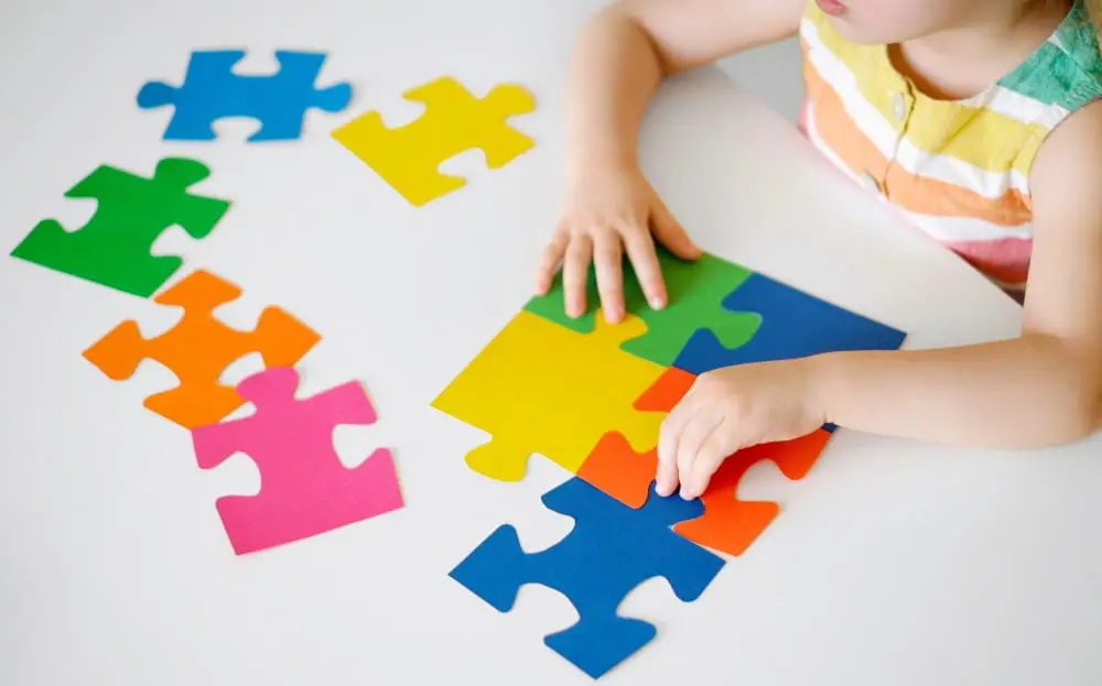 A child playing with puzzle pieces.