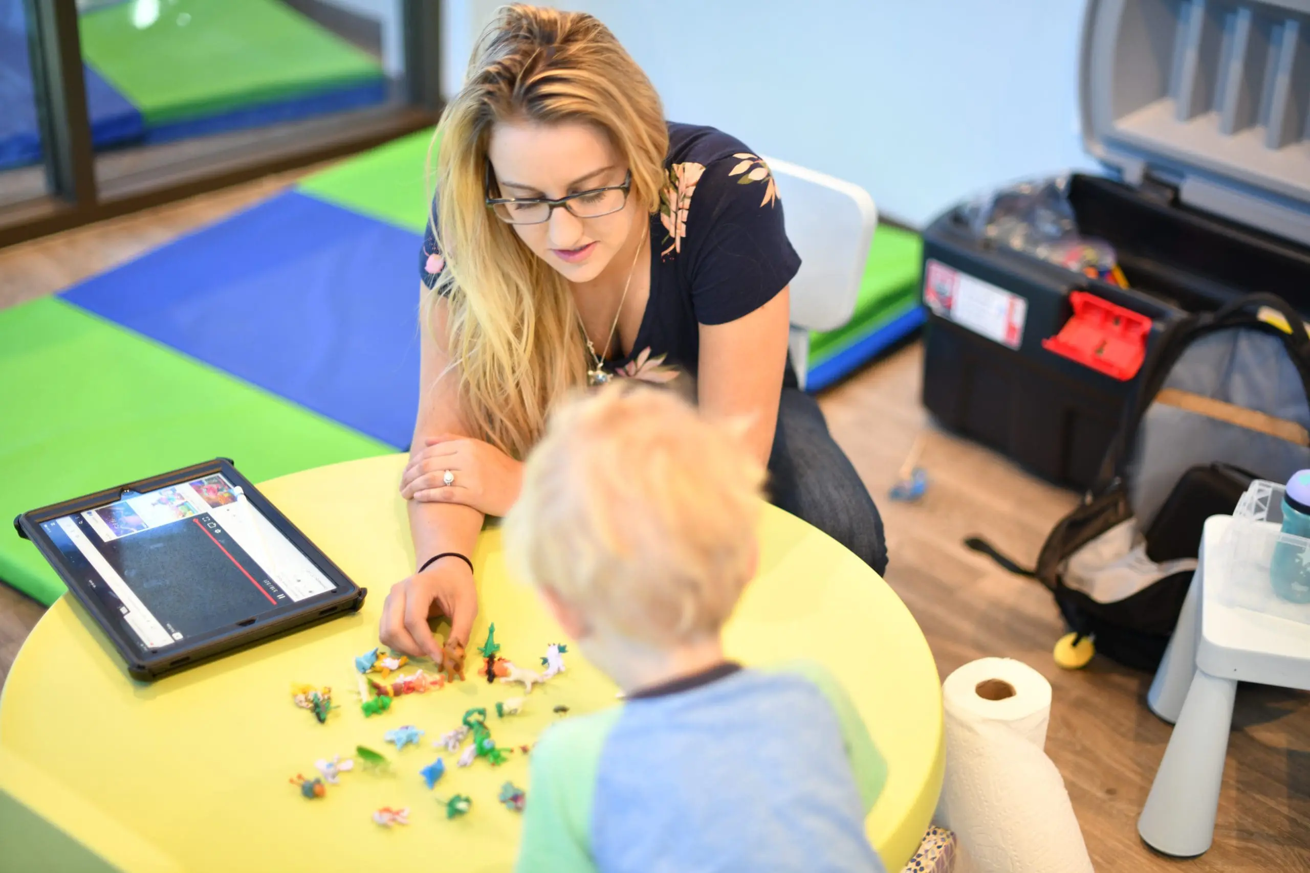 Therapy table setup with educational tools for applied behavior analysis sessions.